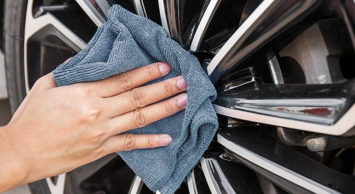 man washing car wheel